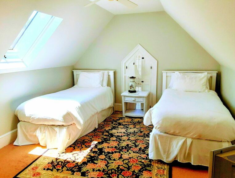 2 twin beds sit under a skylight